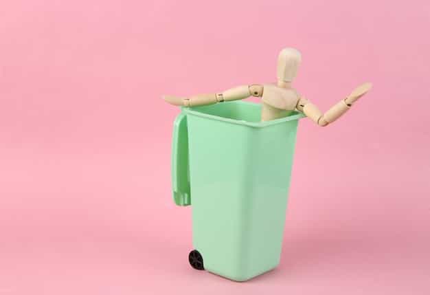 An image showing paperwork falling into a trash can, symbolizing denial of disability benefits application.