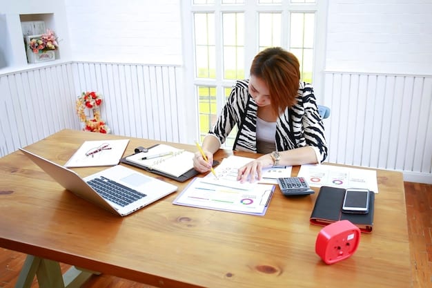 An individual sitting at a desk, using tax preparation software on a laptop, with various documents and forms neatly organized around them. A calculator is nearby.