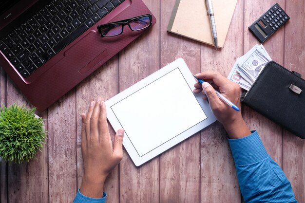 A close-up of the FAFSA website on a tablet, highlighting the section where students input their income and financial information. Hands are shown carefully filling out the form.