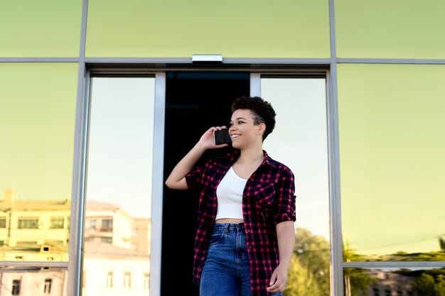 A person answering a video doorbell using a smartphone app, showing a clear image of the visitor at the door, with the house number clearly visible in the background.