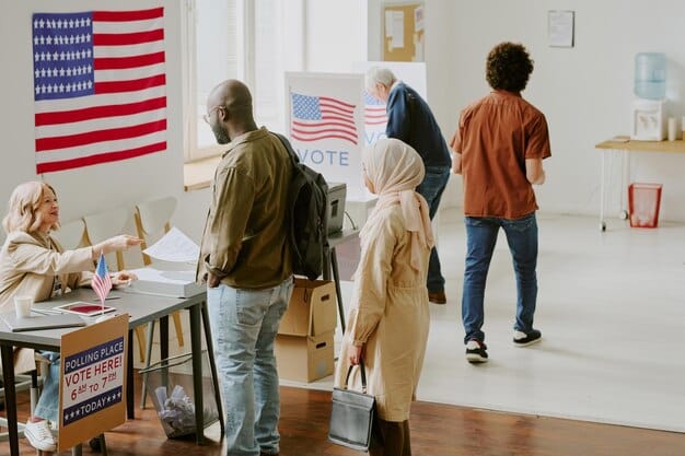 A diverse group of citizens standing in line to vote outside a polling station, emphasizing the importance of voter access and participation in a democratic process.
