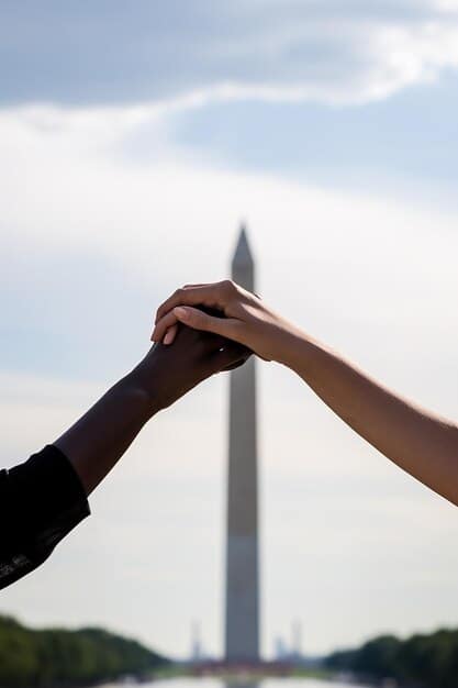 A handshake between two individuals in suits, with the blurred US Capitol Building in the background, symbolizing bipartisan cooperation despite differences.