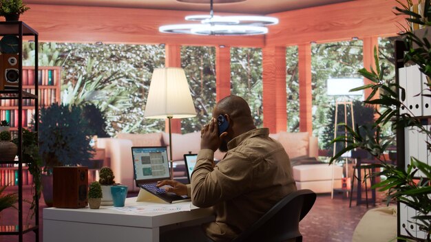 A person working remotely in a bright, modern home office with a laptop, headset, and natural light, simulating the flexible work models of the future. Clean and focused environment.