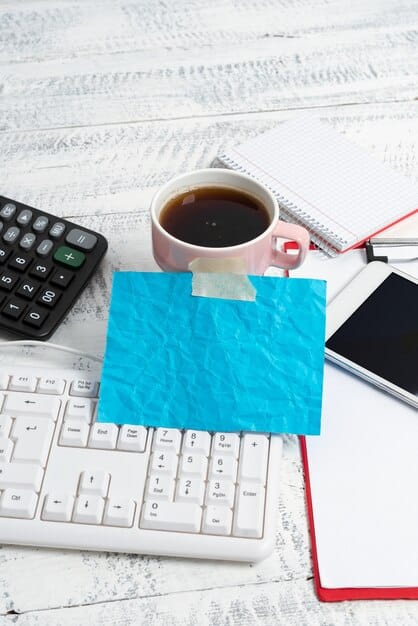 A detailed shot of tax documents and a calculator on a desk, with a calendar in the background, subtly indicating financial planning for unemployment benefits and tax season.