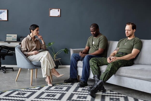 A diverse group of veterans participating in a group therapy session, with a therapist facilitating the discussion in a warm, inviting room.
