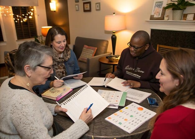 A diverse group of people attending a seminar on homeownership, with a speaker pointing to a slide about FHA loan requirements, conveying education and accessibility.
