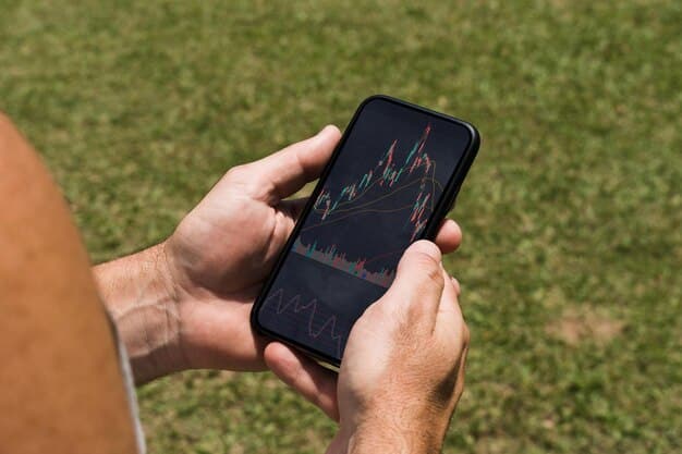 A close-up shot of a hand holding a smartphone displaying stock market charts, while in the background, a person is casually reviewing financial paperwork that includes icons related to pension and investment.