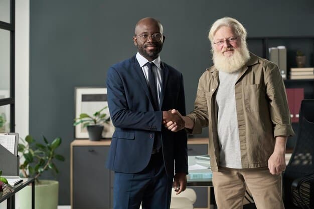 An older federal employee, possibly near retirement, smiling and shaking hands with a younger colleague in an office, symbolizing mentorship and the smooth transition of knowledge and experience.