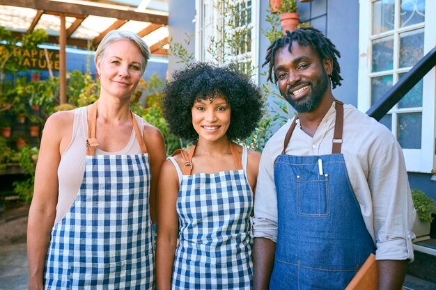 A diverse group of people, including families and small business owners, standing happily in front of a modern home with solar panels, suggesting accessibility and community benefits of renewable energy.