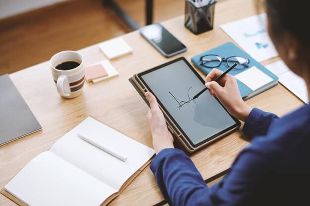 A person attentively reviewing a health insurance statement on a tablet, with financial charts in the background.