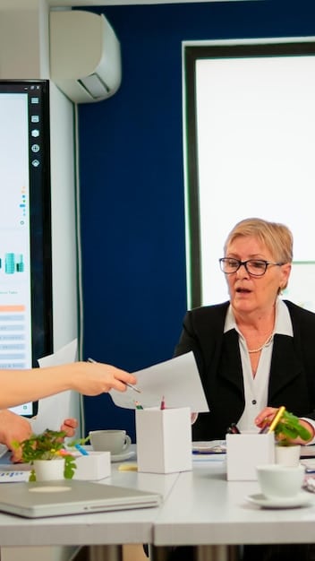 A small business owner receiving a large check from a government official, symbolizing the financial assistance being provided through the new initiatives. The owner is smiling and shaking hands with the official, conveying a sense of gratitude and optimism.