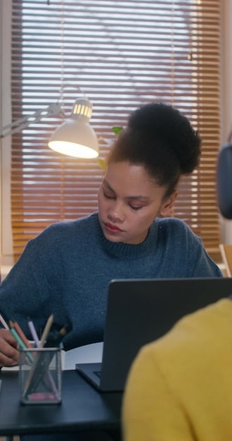 A person (gender neutral) sitting at a desk with a notebook and laptop, actively brainstorming and writing down transferable skills, illustrated with abstract lines connecting different skill bubbles. A coffee mug is nearby.