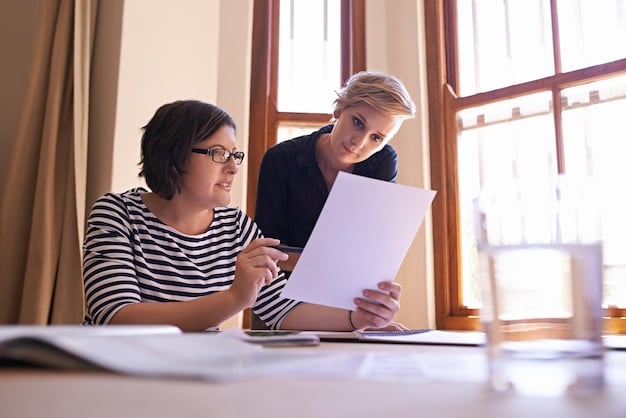 A close-up of two colleagues engaged in a mentoring session. They are reviewing documents and discussing strategies. The setting is a modern office space, highlighting the importance of guidance and support in Leadership Development: Cultivating the Skills to Lead and Inspire Others.