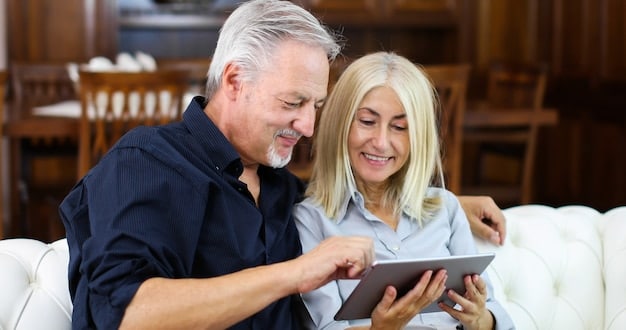 An older couple smiling and holding hands, looking at a tablet showing financial graphs, symbolizing successful retirement planning and security.