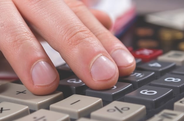 A close-up of hands holding a calculator with a Social Security benefits estimate displayed on a nearby tablet. The image focuses on the calculation and planning aspects of How to Maximize Your Social Security Benefits in 2025: An Insider's Guide.
