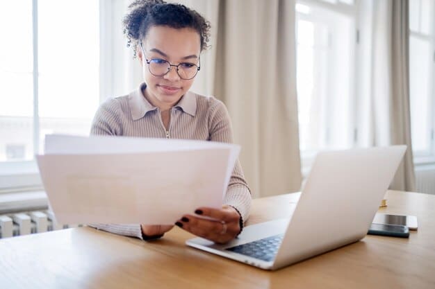 A person typing an appeal letter on a laptop, with stacks of organized documents beside them, emphasizing the importance of a well-prepared and documented appeal when dealing with government benefits claims.