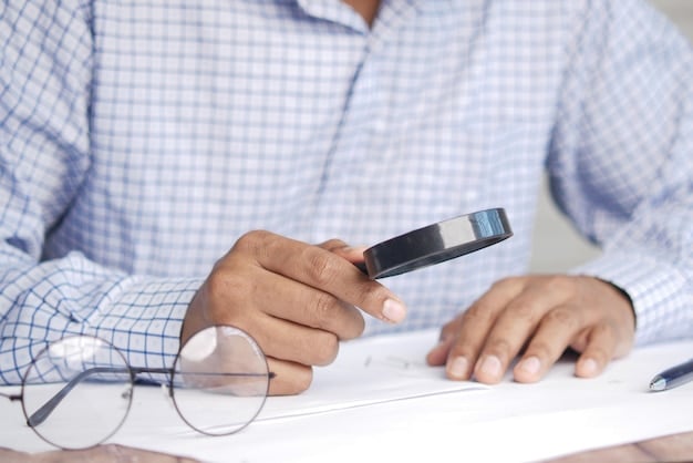 An image of a person filling out a disability benefits application form with a magnifying glass hovering over the form, to highlight the need for accuracy and attention to detail when applying for disability benefits in the US.