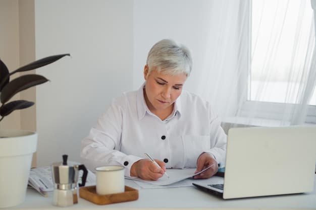 A close-up shot of a senior woman reviewing financial documents at her desk, highlighting the importance of careful planning, potentially related to Social Security and ensuring financial stability in retirement. There is a warm lamp shining on the desk, an open notebook, and stacks of papers and financial reports.