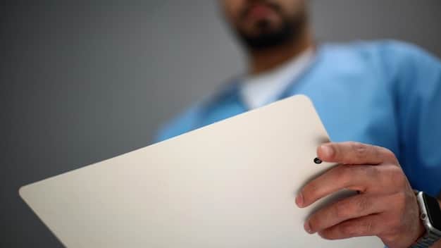 A close-up shot of a hand holding a brochure about Medicare Advantage Plans: Are They Really Worth It? A Data-Driven Comparison for 2025. The lighting is professional and the text is clear and readable.