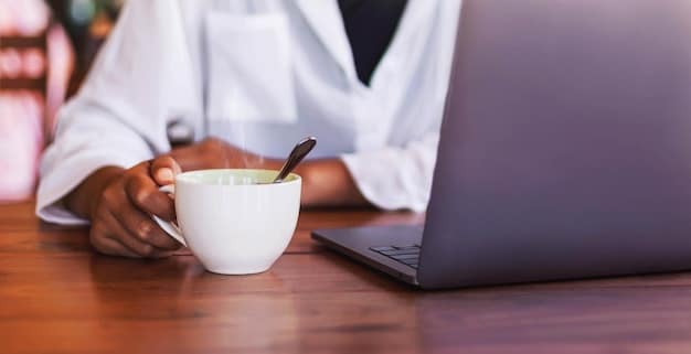 A person sitting at a desk with a laptop open to a healthcare enrollment website, documents spread out, and a cup of coffee, signifying a diligent and informed enrollment process.